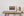 Weathered wooden door panels with pale vertical curtains