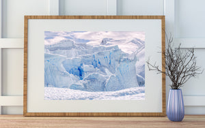 Antarctic fractured ice with a darker blue opening near the centre-left.