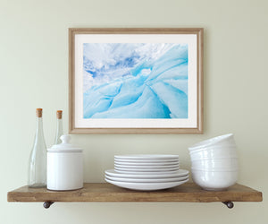 Smooth ice curves and textured blue recesses in an Antarctic iceberg close view.