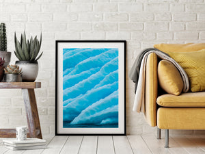 Abstract Antarctic nature photograph of flowing ice ridges and blue surface textures.
