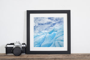 Close Antarctic iceberg detail with blue recesses and pale raised surfaces.