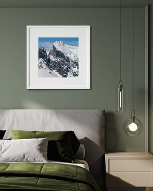 Bright snow slopes above textured Antarctic mountain walls.