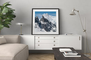 Rocky Antarctic peaks with deep snow gathered in their gullies.