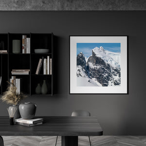 Sunlit Antarctic mountain ridges contrasting with dark exposed rock.