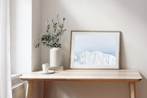Close Antarctic mountain photograph with white snow and subtle blue-grey tones.