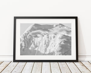 Folds and uneven snow ledges on a rugged Antarctic slope.
