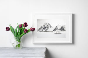 Dark rock and white snow tracing the faces of Antarctic peaks.