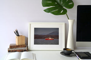 Sunlight highlighting red hull of Antarctic-bound ship