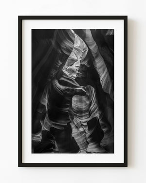 Curved Antelope Canyon sandstone and deep shadows in black and white.