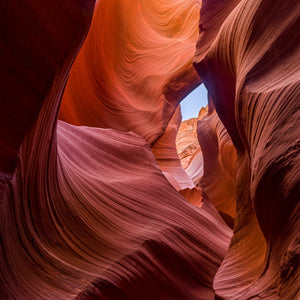 Flowing sandstone walls in Antelope Canyon, Arizona, with mauve shadows.