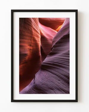 Red and violet sandstone curves inside Antelope Canyon, Arizona.
