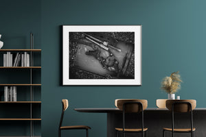 A long threaded rod crosses a tray filled with worn industrial metal pieces.