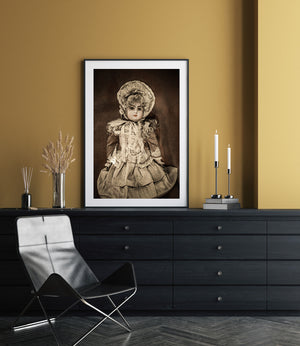 Warm sepia photograph of a porcelain doll against a dark textured background.