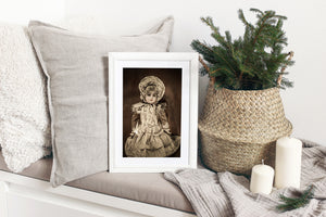 Antique porcelain doll with a lace edged bonnet and softly folded dress.