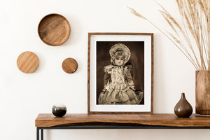 Delicate lace and long ribbons surround an antique porcelain doll in warm tones.