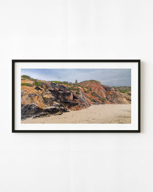 Colourful clay cliffs at Aquinnah rise above a sandy beach beneath Gay Head Lighthouse.