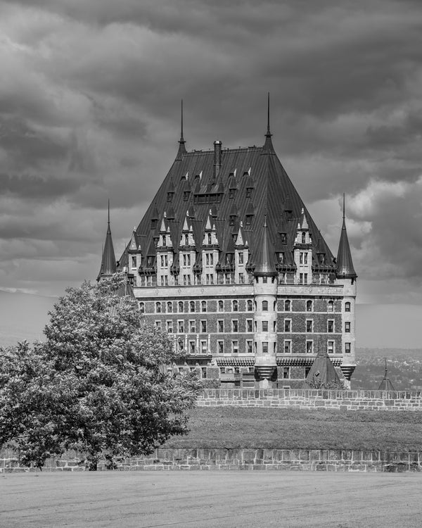 Majestic view of Château Frontenac with dramatic clouds – black and white