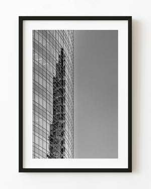 A distorted building reflection crosses a glass facade in Argentina, photographed in black and white.