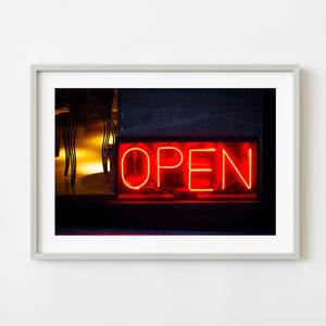 Red neon open sign in Buenos Aires storefront window