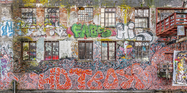 Urban art and windows on weathered warehouse