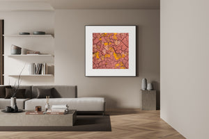 Autumn leaves contrast with dark cracks and warm clay in a dried desert riverbed.