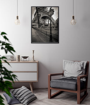 The Eiffel Tower’s arches and iron braces rise behind ornate Avenue Gustave Eiffel lettering.