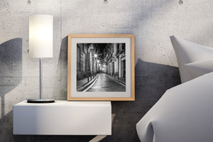 Black and white Barcelona night photograph with starburst streetlights and a bright vanishing point.