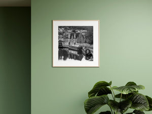 Black and white Bath canal photograph of narrowboats, stone architecture and soft water reflections.