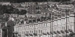 Black and white image of a densely packed residential area with rows of houses.