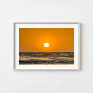 California ocean sunset with warm orange sky