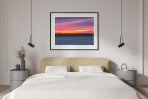 Pink and orange sunset above calm ocean waters
