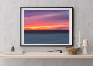 Minimalist seascape featuring colorful dusk sky