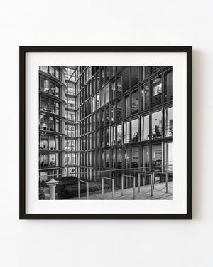 Illuminated glass offices around a Berlin courtyard in black and white