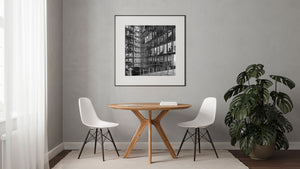 Black and white office architecture with railings and small courtyard plants