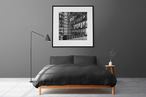 Square monochrome photograph of glass walls enclosing a Berlin courtyard