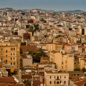 Layered Istanbul homes with red roofs and warm ochre facades