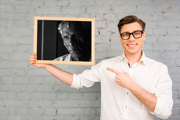 Portrait of elderly man in light and shadow