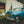 Square colour photograph of a blue classic Plymouth with chrome grille and whitewall tyre.