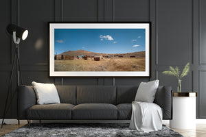 Blue sky and small white clouds above abandoned Bodie buildings