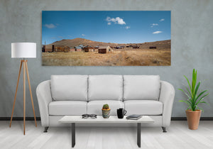Golden grassland stretches toward timber houses in Bodie ghost town