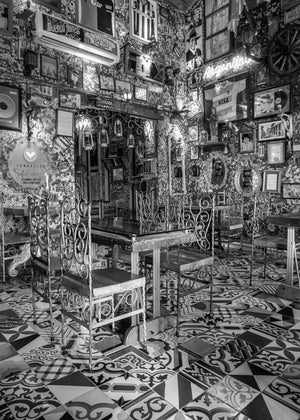 Iron chairs and square tables inside a richly decorated Bogotá restaurant
