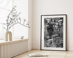 Monochrome Bogotá restaurant photograph with framed pictures and patterned floor tiles