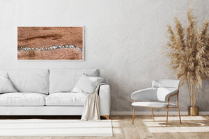 Panoramic seabird colony photograph with textured red cliff faces
