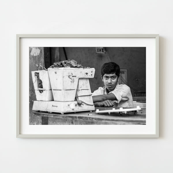 Black and white portrait of young man in industrial setting, Mysore