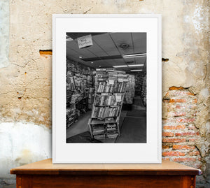 Black and white bookstore photograph with shelves covering the walls