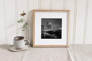 Haze softens tall Boston towers above a waterfront bridge