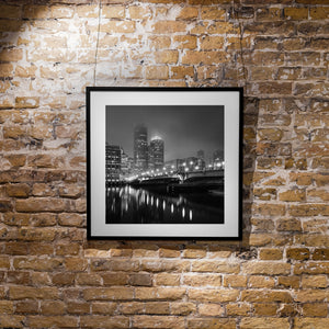 Black and white cityscape of Boston’s illuminated bridge and skyline