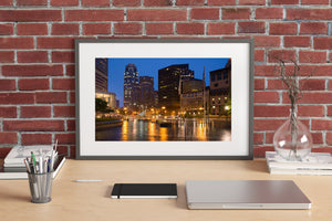 Colour cityscape photograph of Boston’s illuminated Financial District