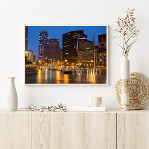 Boston dusk skyline with lit windows and warm street lamps
