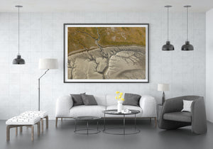 Abstract coastal photograph with branching waterways and an earthy strip of land